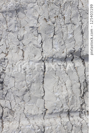 Cracked White Clay Rock with Layered Structure 125403199
