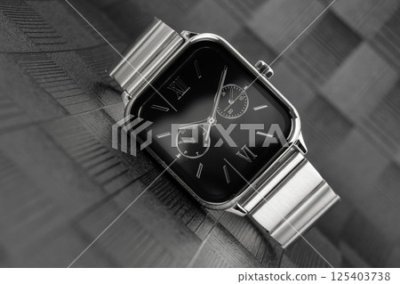 Wristwatch on a dark reflective background. 125403738