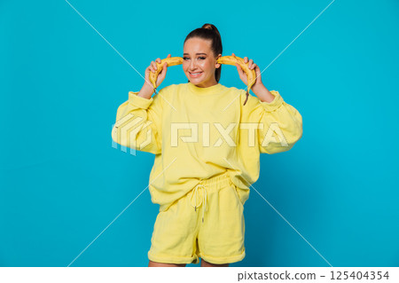 The woman put a banana in her ears The woman put a banana in her ears 125404354