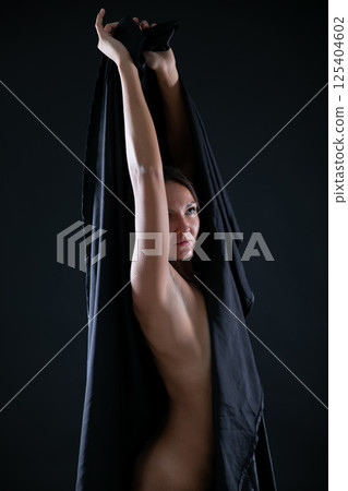 Slim woman in with black fabric on her body 125404602