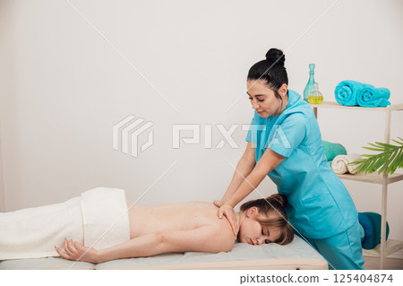 Woman Comes To A Relaxing Medical Massage To A Doctor Woman Comes To A Relaxing Medical Massage To A Doctor 125404874