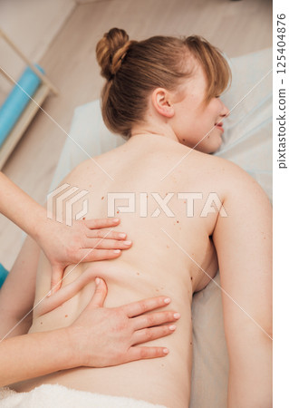 Woman massage therapist doing relaxing medical back massage in spa Woman massage therapist doing relaxing medical back massage in spa 125404876