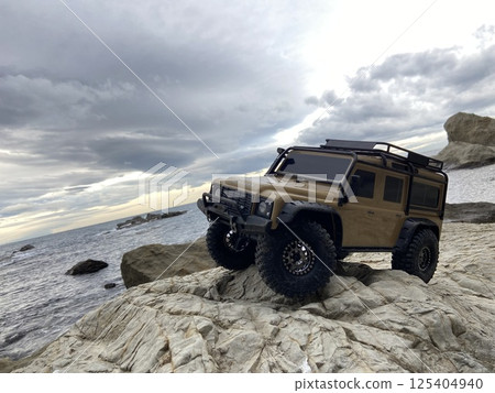 A radio-controlled SUV driving through the rocky terrain of nature 125404940