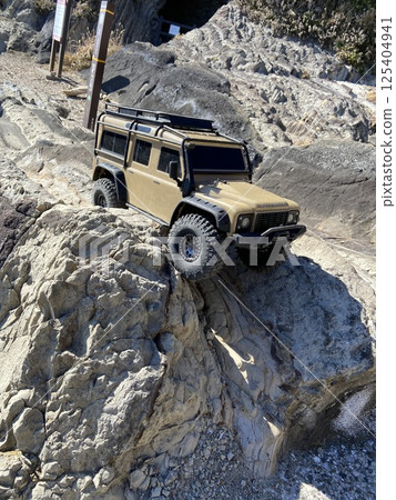 A radio-controlled SUV driving through the rocky terrain of nature 125404941