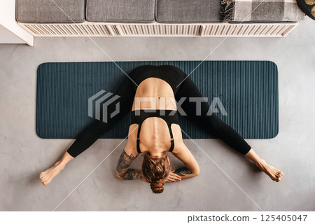 Woman Doing Yoga Exercise on Mat Top View Woman Doing Yoga Exercise on Mat Top View 125405047