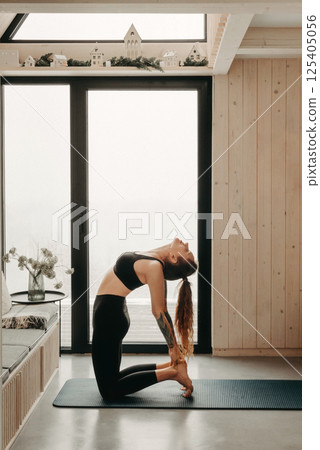 Woman Practicing Yoga Doing Ustrasana Exercise 125405056