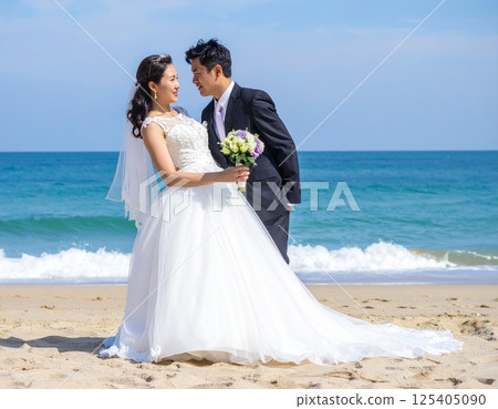 Bride and groom embracing each other on the beach wedding photo 125405090