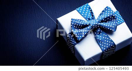 Gift father day. Blue bowtie , gift box with bow ribbon like bowtie on dark blue background.  Fathers Day concept. 125405493