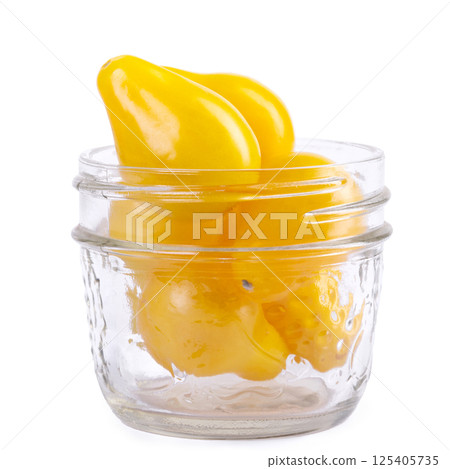 Yellow Pearshaped cherry tomatoes in a jar on white background. Yellow Pearshaped cherry tomatoes in a jar on white background. 125405735