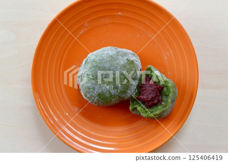 Mugwort Daifuku on a table background viewed from directly above Mugwort Daifuku on a table background viewed from directly above 125406419
