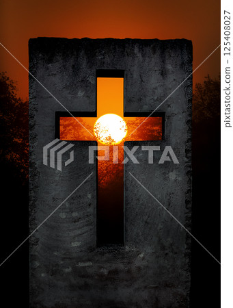 Cross, Christian symbol of hope and faith, cut into stone monument at sunset 125408027