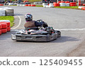 Exciting go-karting adventure on a thrilling racing track during bright afternoon 125409455