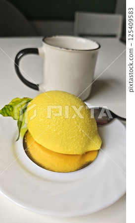 Realistic lemon-shaped mousse dessert Realistic lemon-shaped mousse dessert 125409583
