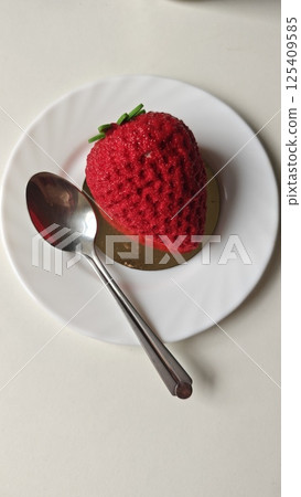 Strawberry-shaped mousse dessert 125409585