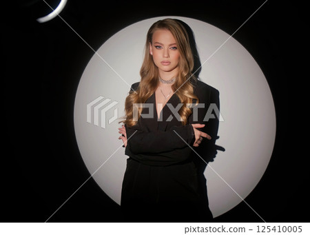 Beautiful blonde in a black jacket and luxurious jewelry around her neck. Beauty portrait and accessories. Beautiful blonde in a black jacket and luxurious jewelry around her neck. Beauty portrait and accessories. 125410005