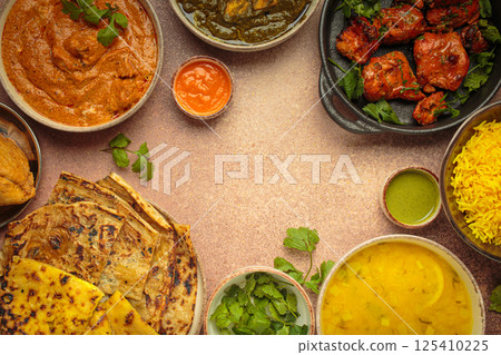 Traditional assorted Indian dishes arranged top view on beige background table. Cuisine of India, space for text Traditional assorted Indian dishes arranged top view on beige background table. Cuisine of India, space for text 125410225