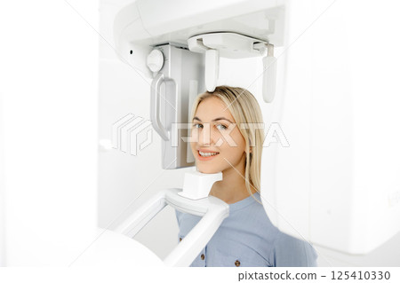 Young woman undergoing a dental panoramic radiography exam 125410330