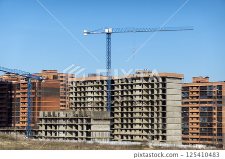 Novorossiysk Two hoisting cranes and buildings under construction Novorossiysk Two hoisting cranes and buildings under construction 125410483