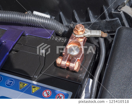 Copper battery terminal of a car close-up 125410518