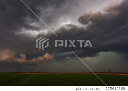 Dramatic storm clouds in the sky, dark severe storm clouds, supercell. Dramatic storm clouds in the sky, dark severe storm clouds, supercell. 125410660