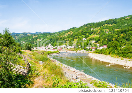 tisza river running through the valley. beautiful view. sunny weather in summer. mountainous countryside landscape of rakhiv region in ukraine. meandering stream 125410704
