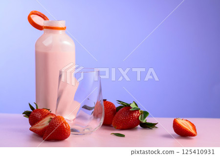 Strawberry milkshake smoothie and fresh berries on a colorful background. 125410931