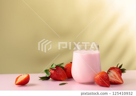 Strawberry yogurt and fresh berries on a colorful background. 125410932