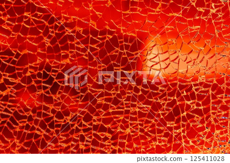 Broken tempered glass. Glass web of cracks. Changed color scheme. Colorful background. 125411028