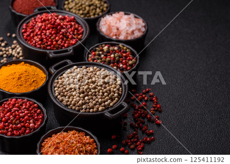 Variations of spices, allspice, turmeric, paprika, salt in ceramic bowls Variations of spices, allspice, turmeric, paprika, salt in ceramic bowls 125411192