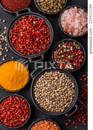 Variations of spices, allspice, turmeric, paprika, salt in ceramic bowls Variations of spices, allspice, turmeric, paprika, salt in ceramic bowls 125411194