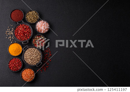 Variations of spices, allspice, turmeric, paprika, salt in ceramic bowls Variations of spices, allspice, turmeric, paprika, salt in ceramic bowls 125411197