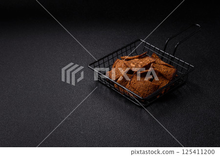 Crispy homemade brown bread chips with seeds and grains, salt, spices Crispy homemade brown bread chips with seeds and grains, salt, spices 125411200