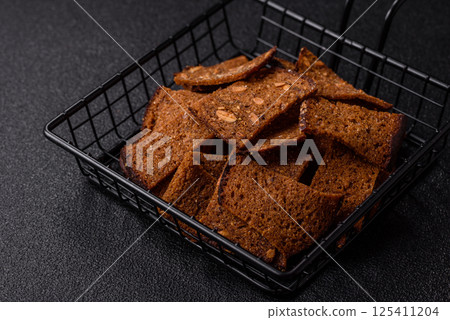 Crispy homemade brown bread chips with seeds and grains, salt, spices 125411204