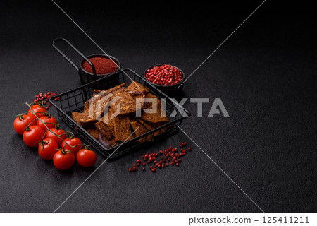 Crispy homemade brown bread chips with seeds and grains, salt, spices 125411211