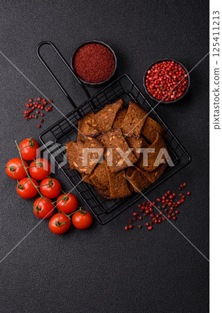 Crispy homemade brown bread chips with seeds and grains, salt, spices 125411213