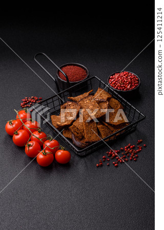Crispy homemade brown bread chips with seeds and grains, salt, spices 125411214