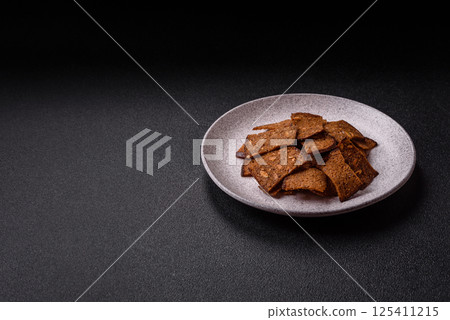 Crispy homemade brown bread chips with seeds and grains, salt, spices Crispy homemade brown bread chips with seeds and grains, salt, spices 125411215
