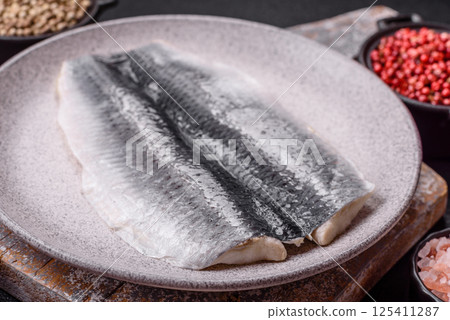 Herring fillet salted and marinated with salt, spices and oil Herring fillet salted and marinated with salt, spices and oil 125411287