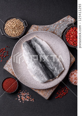 Herring fillet salted and marinated with salt, spices and oil Herring fillet salted and marinated with salt, spices and oil 125411293