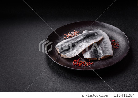Herring fillet salted and marinated with salt, spices and oil Herring fillet salted and marinated with salt, spices and oil 125411294