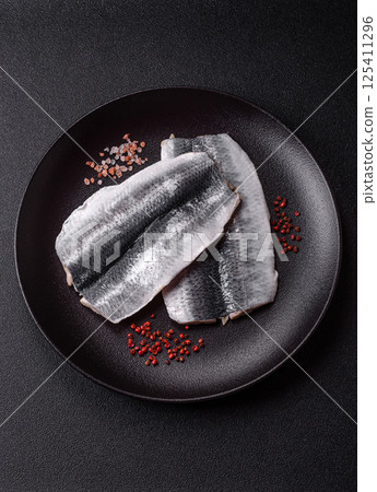 Herring fillet salted and marinated with salt, spices and oil Herring fillet salted and marinated with salt, spices and oil 125411296