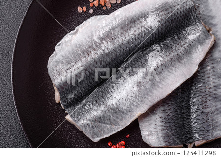 Herring fillet salted and marinated with salt, spices and oil Herring fillet salted and marinated with salt, spices and oil 125411298