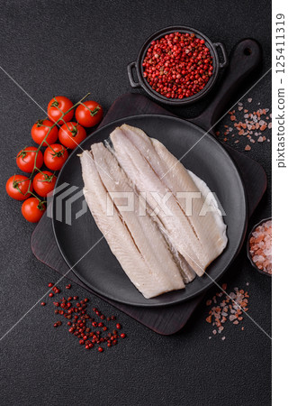 Herring fillet salted and marinated with salt, spices and oil 125411319