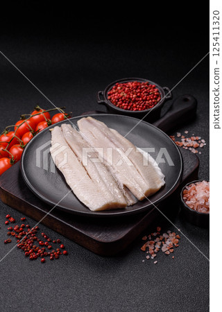 Herring fillet salted and marinated with salt, spices and oil 125411320