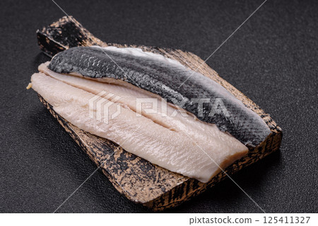 Herring fillet salted and marinated with salt, spices and oil 125411327
