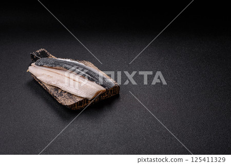Herring fillet salted and marinated with salt, spices and oil 125411329