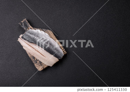 Herring fillet salted and marinated with salt, spices and oil Herring fillet salted and marinated with salt, spices and oil 125411330