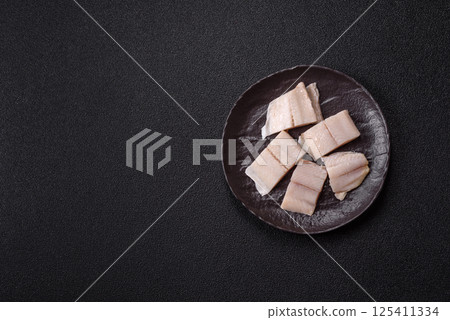 Herring fillet salted and marinated with salt, spices and oil Herring fillet salted and marinated with salt, spices and oil 125411334