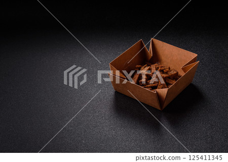 Crispy homemade brown bread crackers or croutons with seeds and grains 125411345