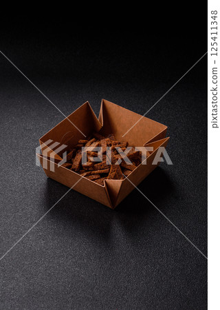 Crispy homemade brown bread crackers or croutons with seeds and grains 125411348